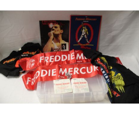 A lot of Freddie Mercury items with scarves and t-shirts and a badge and programmes with ticket stubs - Queen interest