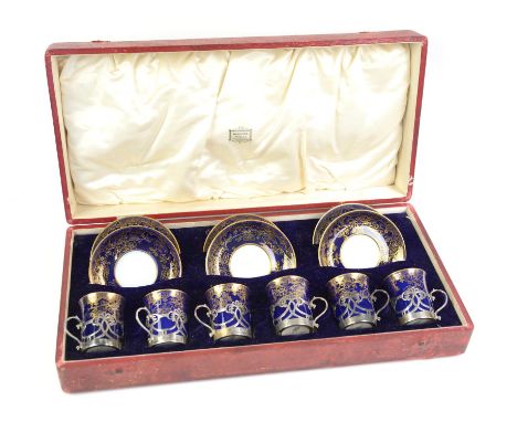 Harrods boxed and retailed set of six coffee cans and saucers with silver cup holders by Robert Fead Mosley, Sheffield 1921.C