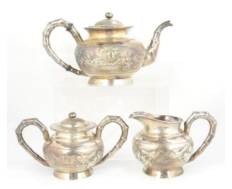 Chinese silver three piece tea service with simulated bamboo handlesCondition Report:  Rubbing to decoration and some rubbing