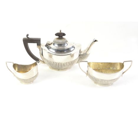 George V Bachelor's silver  tea service, comprising tea pot, cream jug and sugar bowl with half gadrooned bodies, by William 