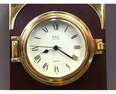 the brass clock and barometer on a mahogany plaque, along with a a modern brass bulkhead clockbrass clock/barometer 78cm high