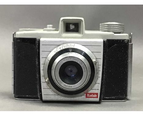 includind Kodak and Agfa cameras, Victorian leather tape measure and a pair of field glasses, contained in a vintage leather 