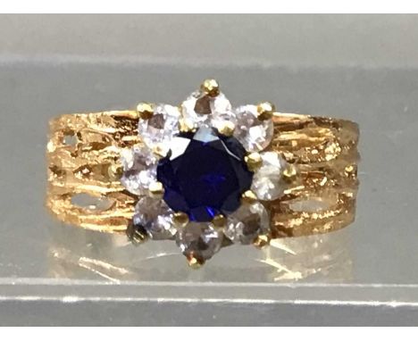 one ring with floral gem set cluster 