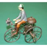 A rare French mid 1800's clockwork tricycle. A simple metal framed bike with metal spoked wheels,