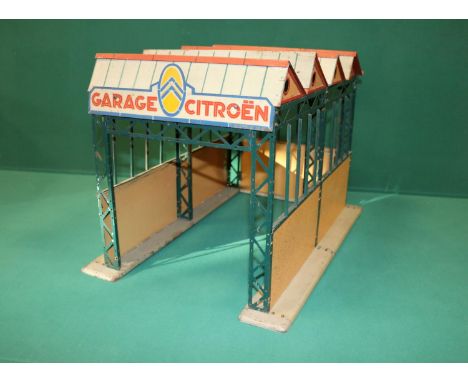 A rare CIJ (ref325) tinplate Citroen garage. With a very original metal architecture, complete with all parts to its warehous