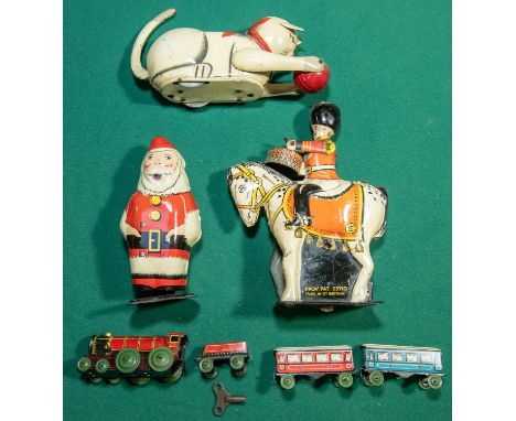 4 vintage Clockwork tinplate toys. Wells Brimtoy Santa Clause with walking action, Drummer on horseback with drumming action.