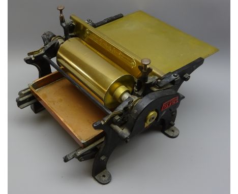 Early 20th century cast iron Prakma manual poster Gluing machine with copper tray, brass rollers and bed, No.11197, W33cm, D2