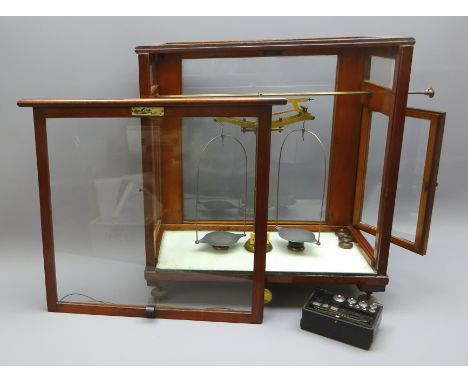 Set of brass Scientific balance Scales stamped  L.Oertling, London E.C. with a part set of Griffin & Tatlock weights, in glaz