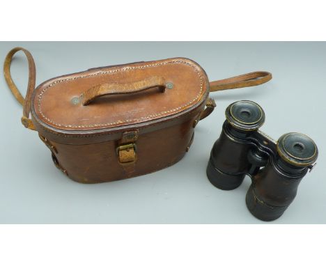 Pair of J H Steward leather covered WWI adjustable magnification Binoculars with Theatre, Field & Marine settings, the leathe