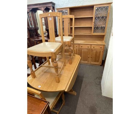 Light oak glazed door topped dresser, drop leaf dining table and four chairs.