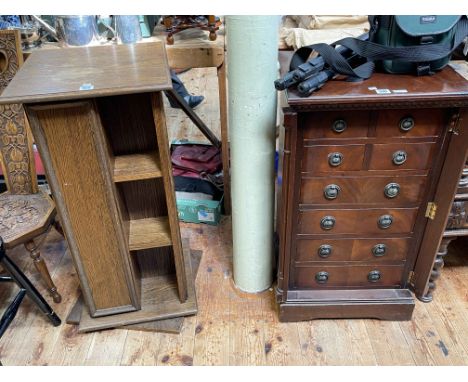 Mahogany eight drawer Wellington chest and oak finish revolving bookcase/CD rack.