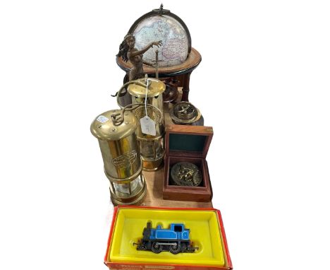 Two brass miners lamps, table top globe, compass, figure, etc.