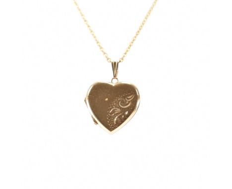 A hallmarked 9ct yellow gold heart locket &amp; chain necklace. The locket having etched scrolling decoration &amp; a hinged 