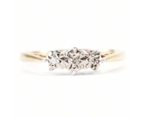 A hallmarked 9ct gold and diamond three stone ring. The ring set with three round brilliant cut diamonds to an&nbsp; illusion