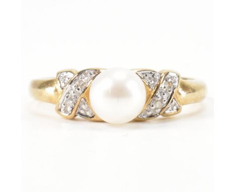 A hallmarked 9ct gold pearl ring. The ring set with a cultured pearl to diamond kiss set shoulders and plain shank. Weight 2.