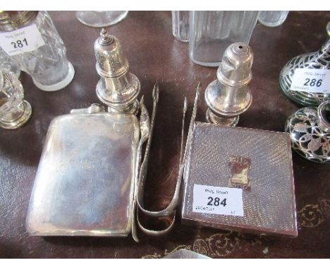 A silver cigarette box, together with a hip flask, two condiment pots, two pairs of tongs, and a condiment spoon