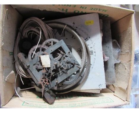 A collection of clock parts, to include dials, pendulums, keys, etc.