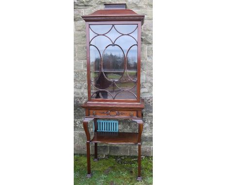 An Edwardian mahogany display cabinet, with C scroll glazing bars, the base fitted with a drawer over a shelf, width 27.5ins,