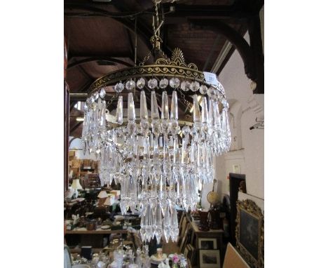 A gilt metal three tier light fitting with droppers