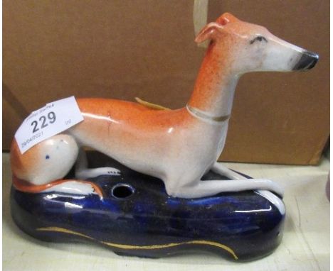 A Staffordshire&nbsp; model of a recumbent greyhound