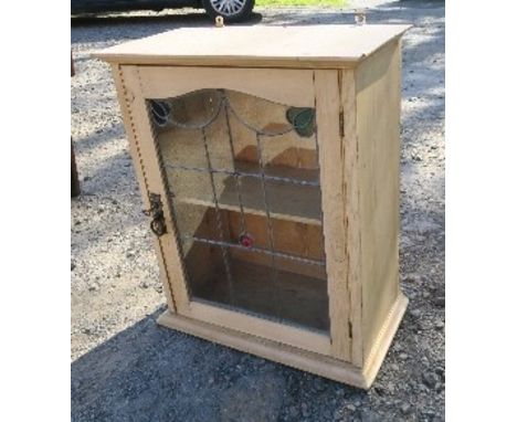 A pine wall cabinet, with stained glass door, opening to reveal shelf, width 20.75ins x height 25ins x depth 11.5ins