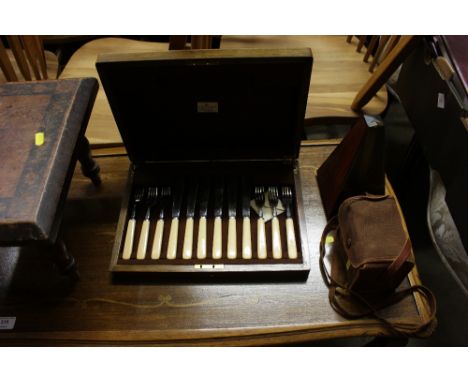 A metronome; a boxed camera; and a part canteen of fish knives and forks 