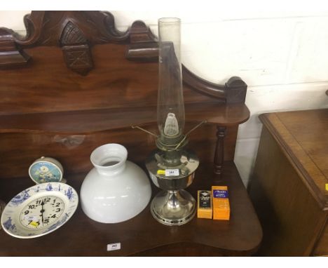 An oil lamp with milk glass shade 