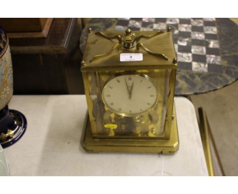 A brass cased thousand day clock