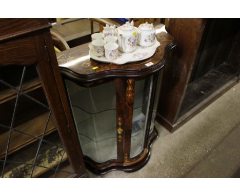 An Italian serpentine front and glazed display cabinet 