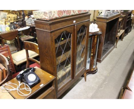 An oak and leaded glazed display cabinet 