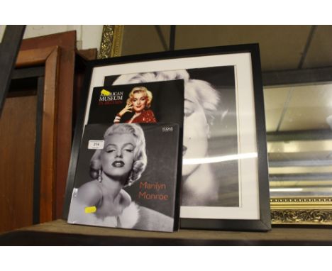 A black and white photographic print depicting Marilyn Monroe; and two relating books 
