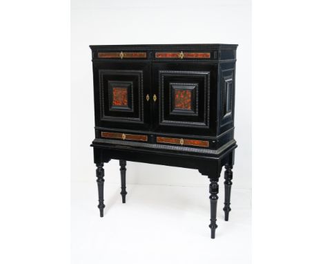 A 19th century Antwerp style ebony and tortoiseshell veneered and ebonised cabinet on standthe plain top over two drawer frie