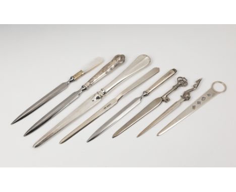 A collection of five silver letter openersto include one in the form meat skewer by Mappin &amp; Webb; one with a dolphin fin