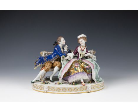 A large Continental porcelain figural groupprobably German, early 20th century, of a Gallant and his companion seated on a be