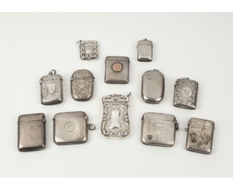 A small collection of silver vesta cases to include a silver vesta case of typical form with central circular rose gold carto