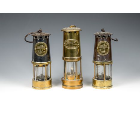 A pair of brass and steel mining lamps by The Protector Lamp &amp; Lighting Co. Ltd.type MG40, 9½in. (24cm.) high plus hooks;