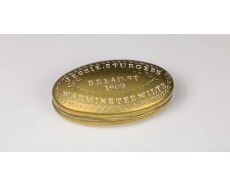 An Edwardian brass snuff boxrounded oval shaped box with hinged lid inscribed 'Jessie. Sturgess, Bread St, 1909, Warminster. 
