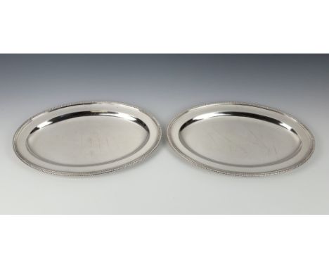 A pair of George III silver oval platters by Paul StorrLondon 1798, with gadrooned rims, crested, 13 x 8¾in. (33 x 22.25cm.),