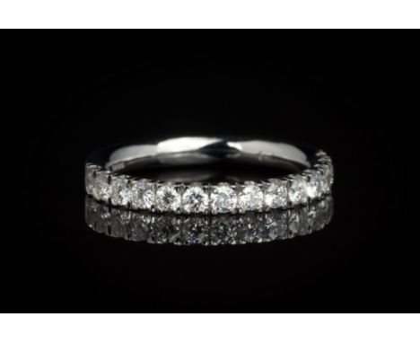An 18ct white gold and diamond half eternity ringwith fourteen claw set brilliant cut diamonds, total 0.55cts, ring size K.