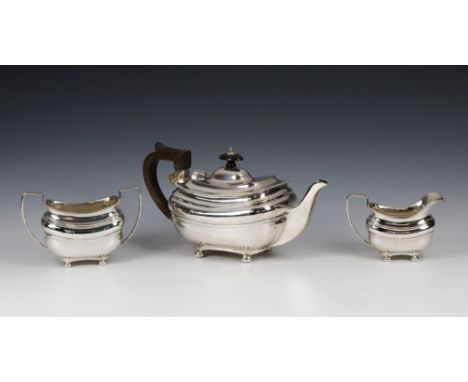 A George V silver three piece tea serviceAlbert Faulkner, Sheffield 1918, of squat bulbous form, gadrooned rims, raised on fo