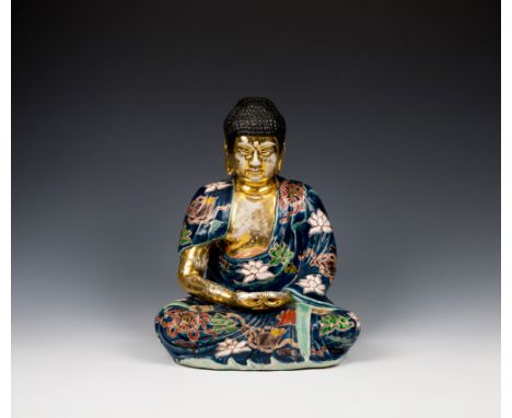 A Chinese porcelain figure of a seated Buddhain the Qianlong style, early 20th century, with black hair, gilt body and dark b