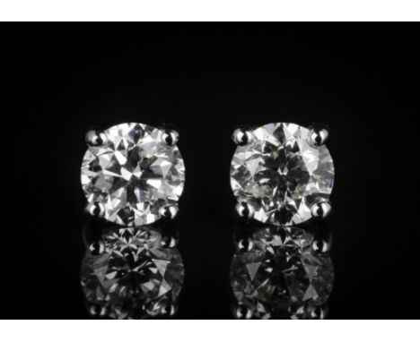 A pair of 18ct white gold and diamond stud earrings, the brilliant cut diamonds totalling 1.24cts, with WGI certificate, H-K/