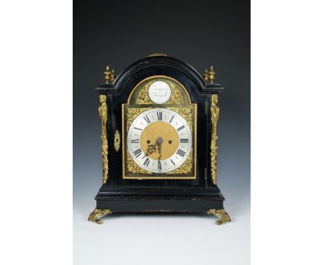 A 19th century ebonised bracket clockwith gilt brass caryatid mounts, finials and feet, carrying handle to top of case, the b