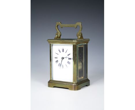 A gilt brass carriage clockearly to mid-20th century, Corniche case with twin train movement, Roman enamel dial, 4¾in. (12cm.