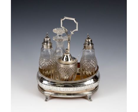 A George III silver cruet stand Peter & William Bateman, London, 1812, bright-cut decoration, central carrying handle, on fou
