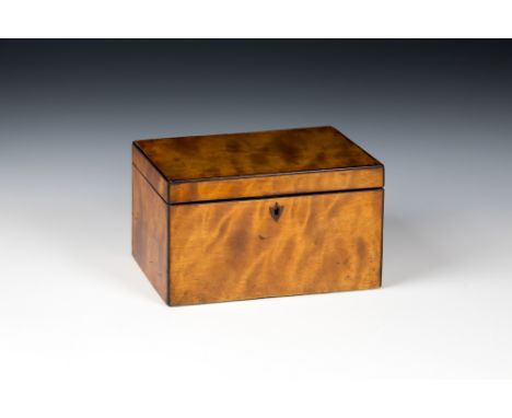 A George III satinwood tea caddyof rectangular form, the hinged lid opening to reveal two lidded compartments with turned ivo