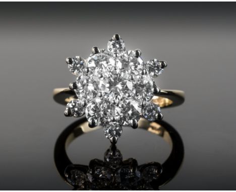 An 18ct yellow gold and diamond floral cluster ring, the thirteen brilliant cut diamonds of good clarity and colour in a six 
