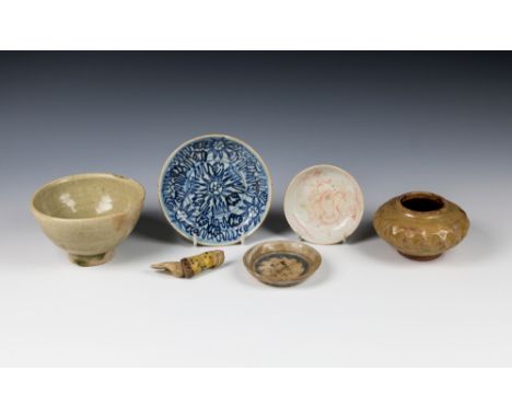 A small collection of ancient Chinese and Burmese potteryin varying shapes and designs, together with a small painted wooden 