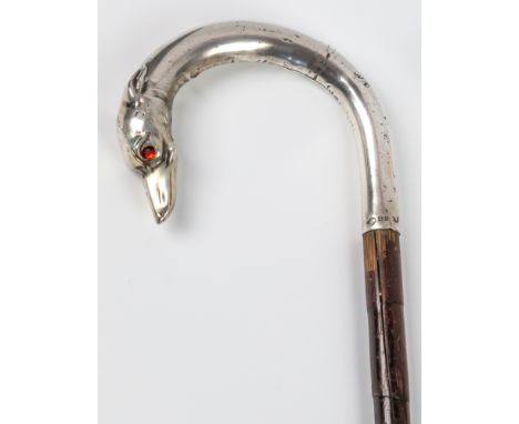 A novelty walking stick with silver dog's head handlethe slender bamboo cane terminating in a silver scroll handle with dog's