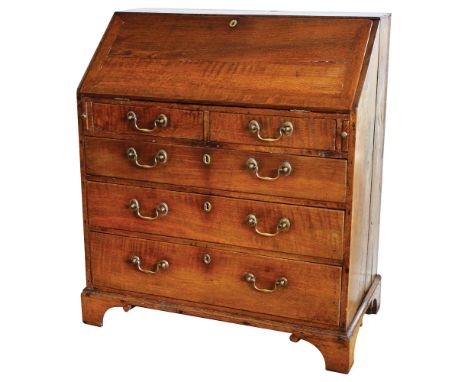 A George II oak bureauwith fitted interior with bank of sixteen drawers and a well with sliding cover, the base with two shor